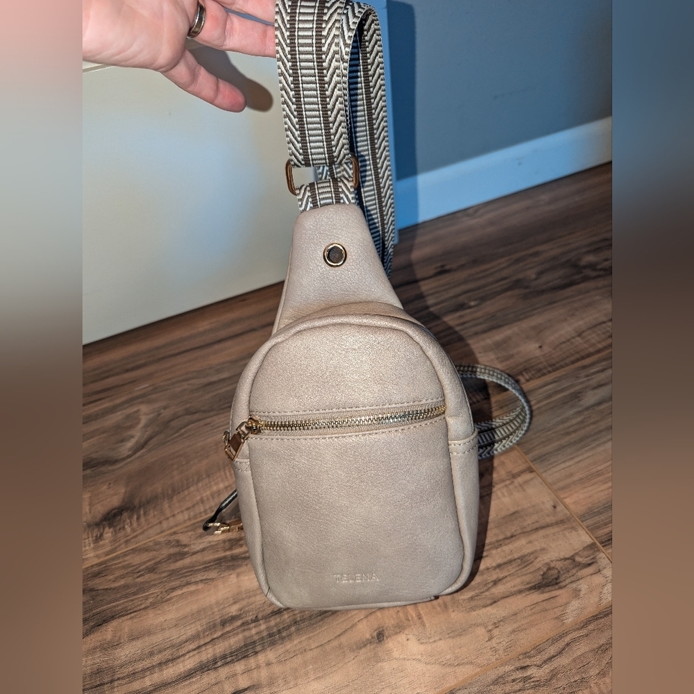 Telena tan sling mini back pack with adjustable strap.